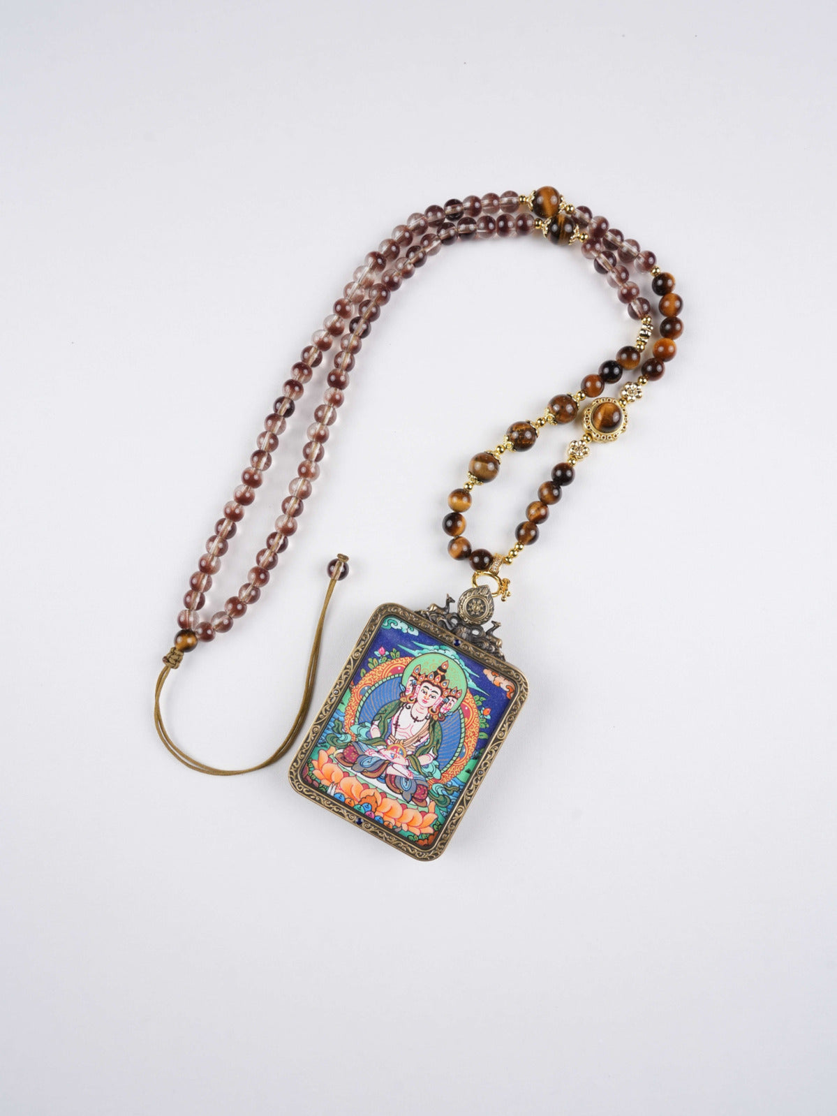 Zodiac amulet pendant of Vairocana Buddha hand-painted with natural mineral pigments on canvas.