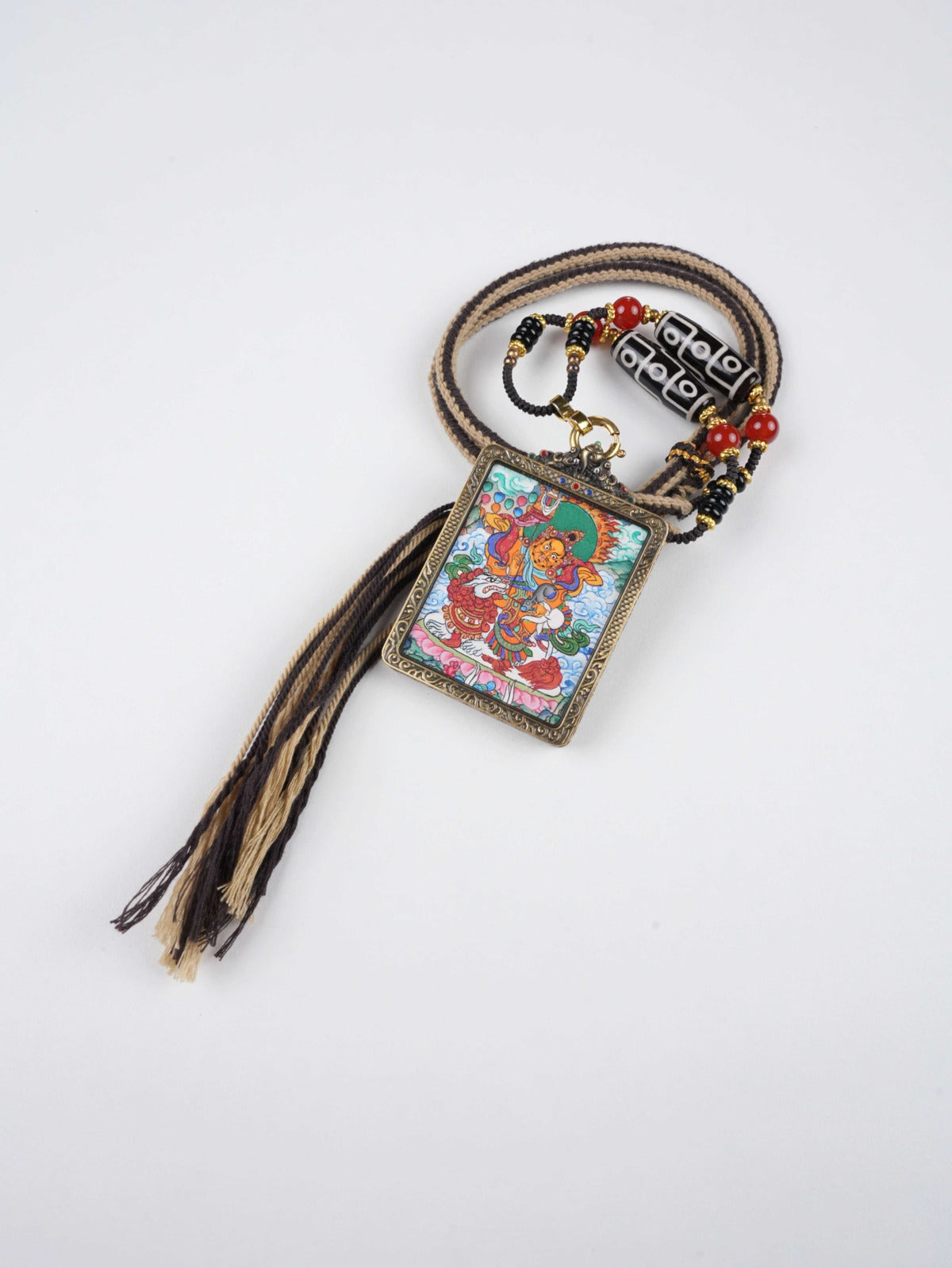 Vaishravana thangka pendant with mineral pigments - authentic hand-painted craftsmanship for wealth blessing