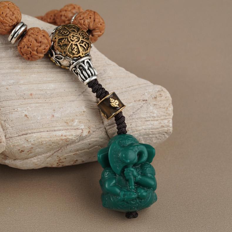 Tibetan-inspired Bodhi and glass bead talisman strand with copper beads.