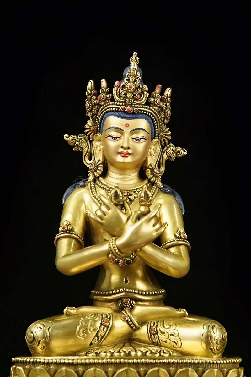 Detailed close-up of a handmade Vajradhara statue, featuring masterful gold gilding on brass, exemplifying Tibetan Buddhist art.