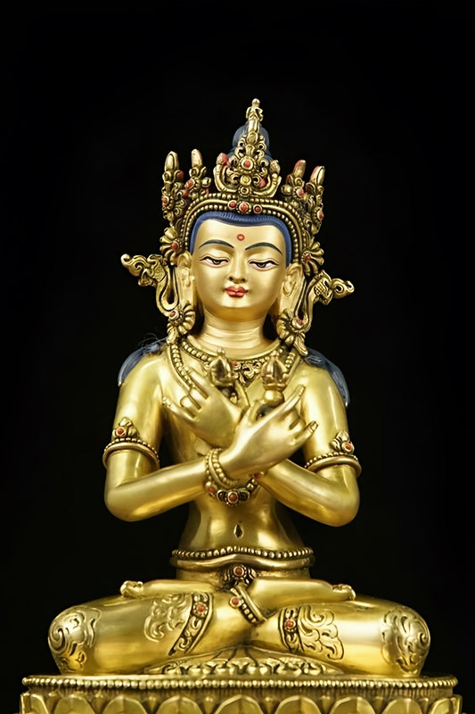 Detailed close-up of a handmade Vajradhara statue, featuring masterful gold gilding on brass, exemplifying Tibetan Buddhist art.