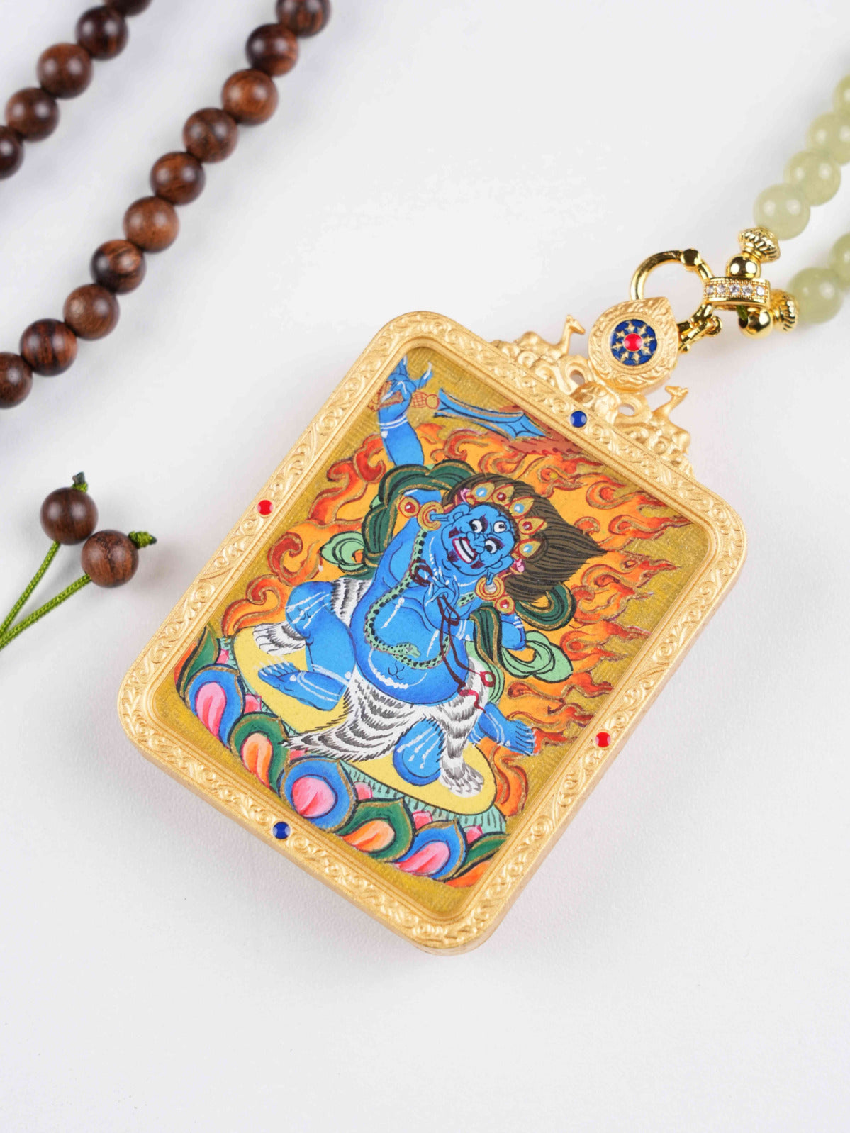 Vajrapani Thangka painting pendant handcrafted with mineral pigments for obstacle protection.