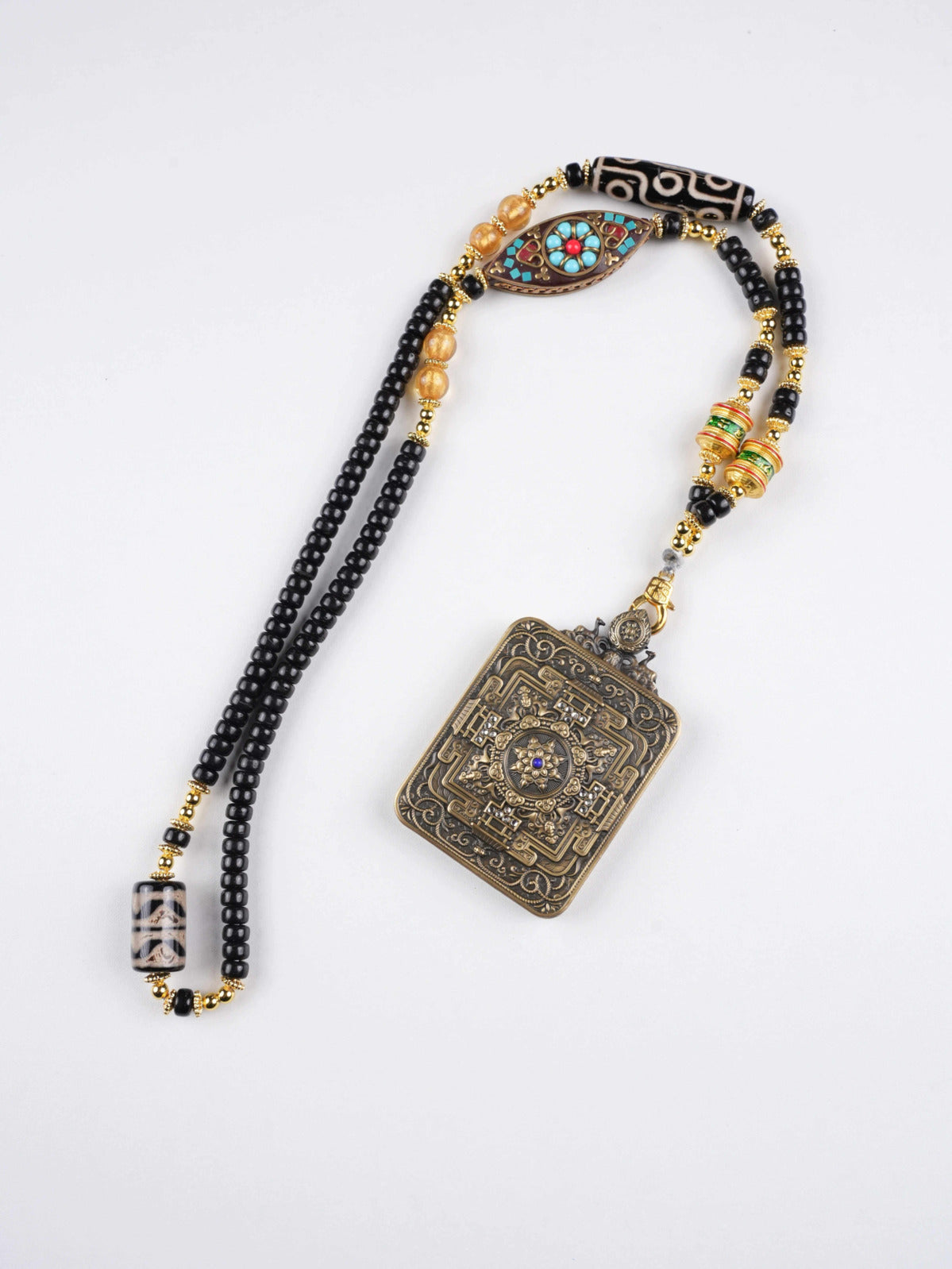 Tibetan Buddhist Jambhala wealth charm hand-painted on thangka canvas for prosperity and protection.