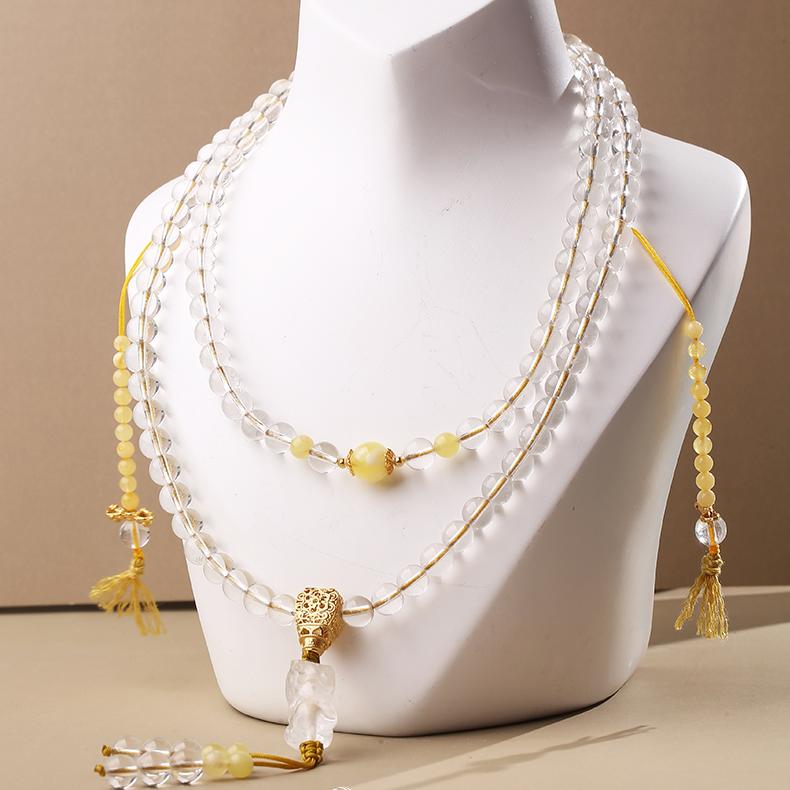 Tibetan handcrafted mala with white crystal, amber, and Pi Xiu pendant symbolizing wealth and peace.