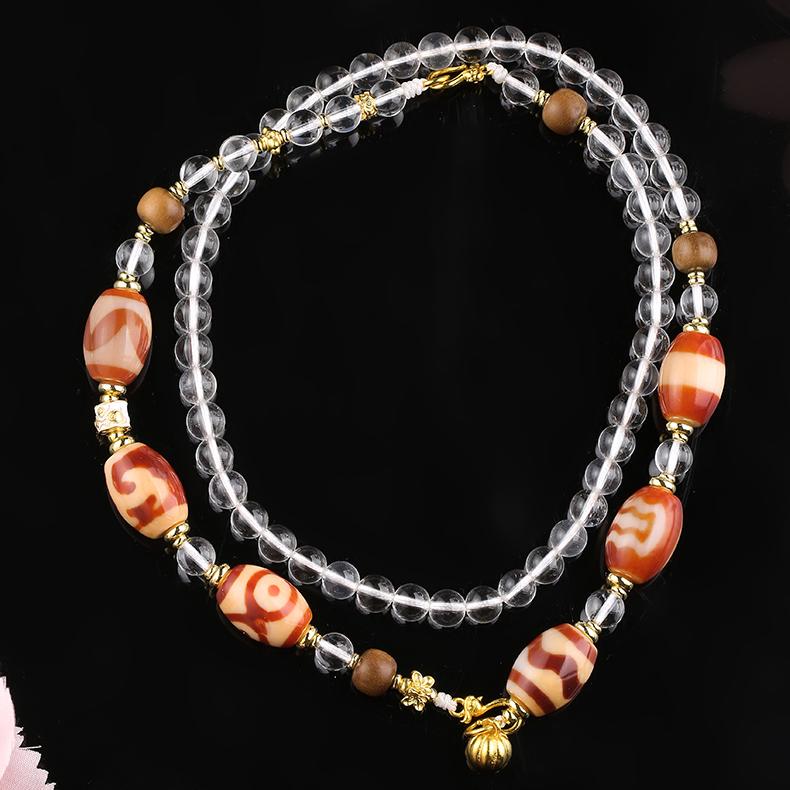 Handmade Tibetan Buddhist white crystal and red agate bead necklace with copper and old sandalwood beads for protection and vitality.