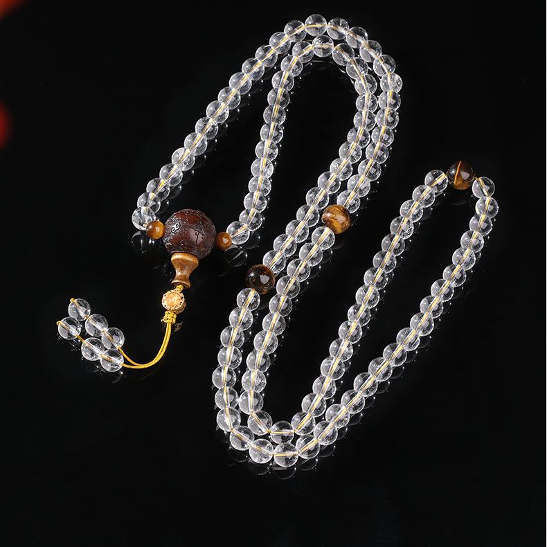 Sandalwood and white crystal mala necklace featuring tiger eye beads for balance and grounding.