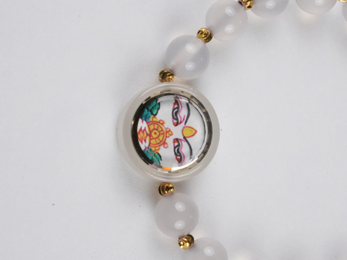 Mini Tibetan Buddhist White Tara thangka bracelet artwork, symbolizing purity and peace in traditional Tibetan Buddha art style.