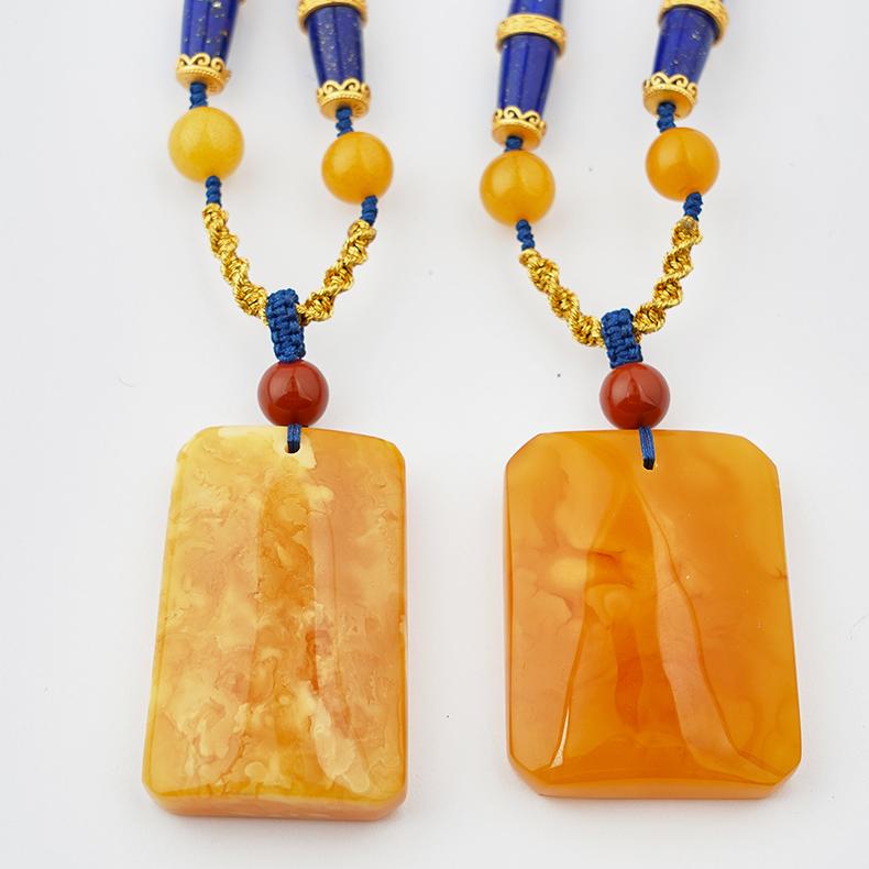 Sacred Tibetan jewelry art pendant made from amber and lapis lazuli.