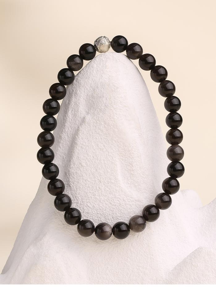 Handcrafted Tibetan-Buddhist silver obsidian bracelet featuring polished 6mm beads and a 925 silver Om Mani Padme Hum bead.