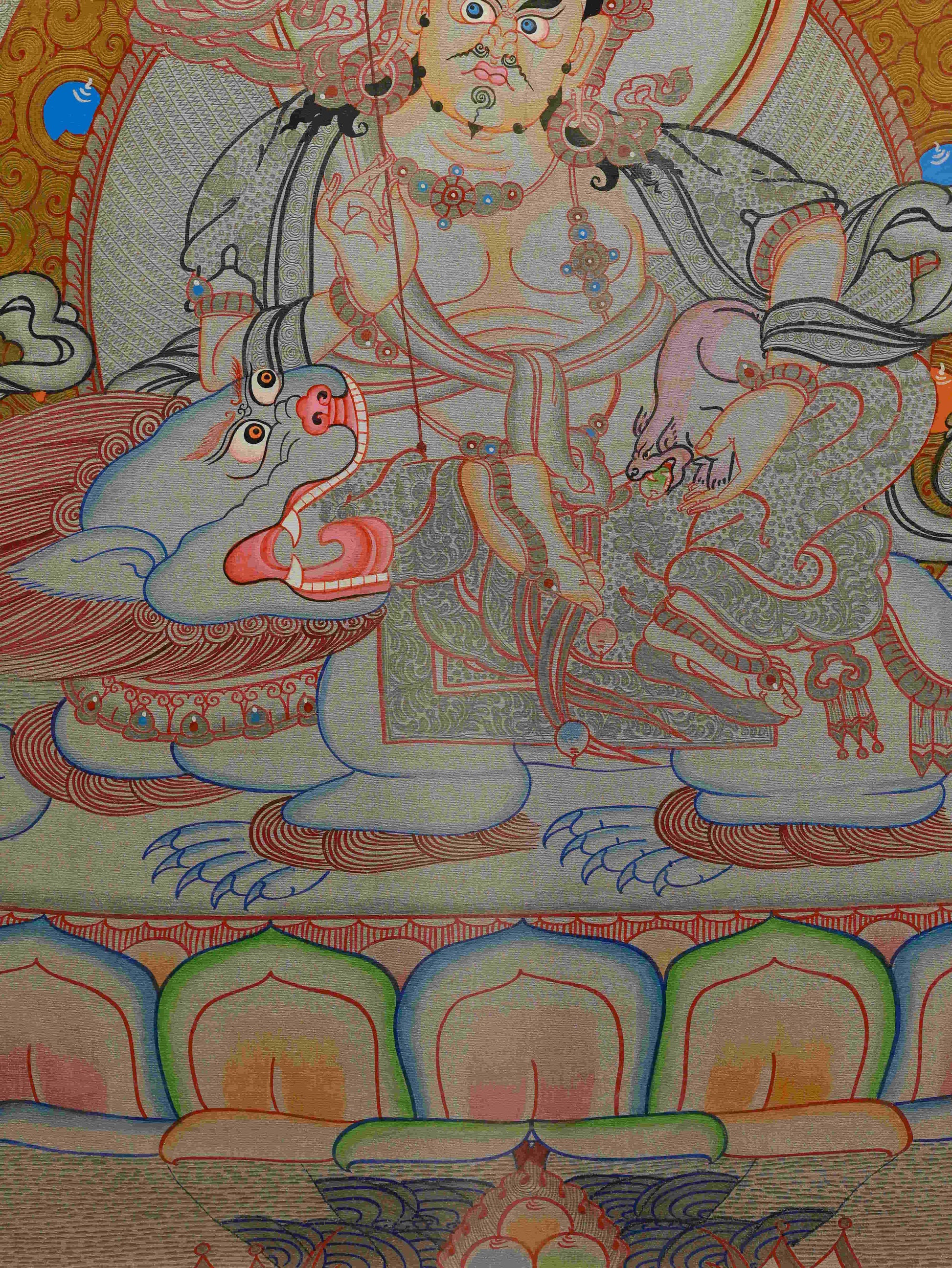 Tibetan Thangka painting of Yellow Dzambhala, the deity of prosperity.