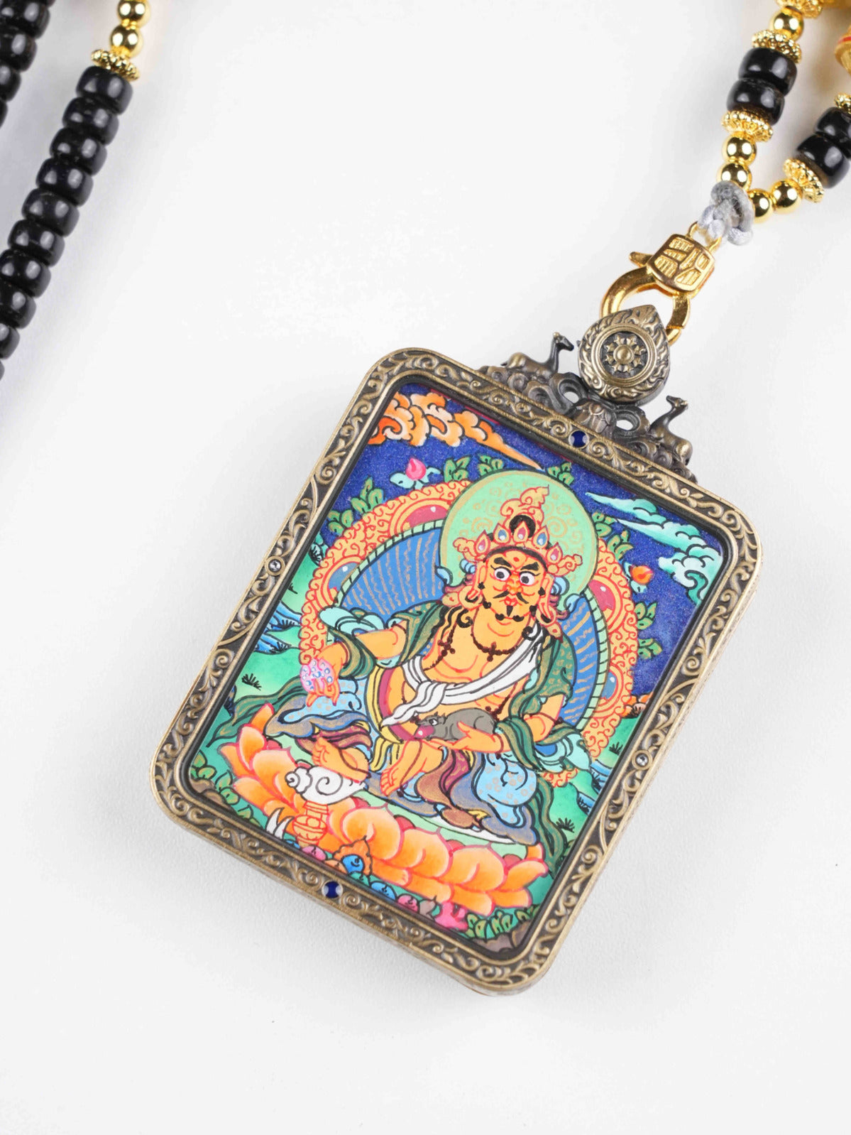 Sacred Yellow Jambhala thangka pendant symbolizing generosity, wisdom, and abundance.