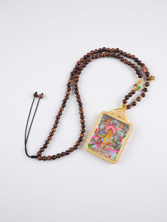 Close-up of Yellow Jambhala thangka painting showing vibrant mineral pigments and pure hand-painted details.