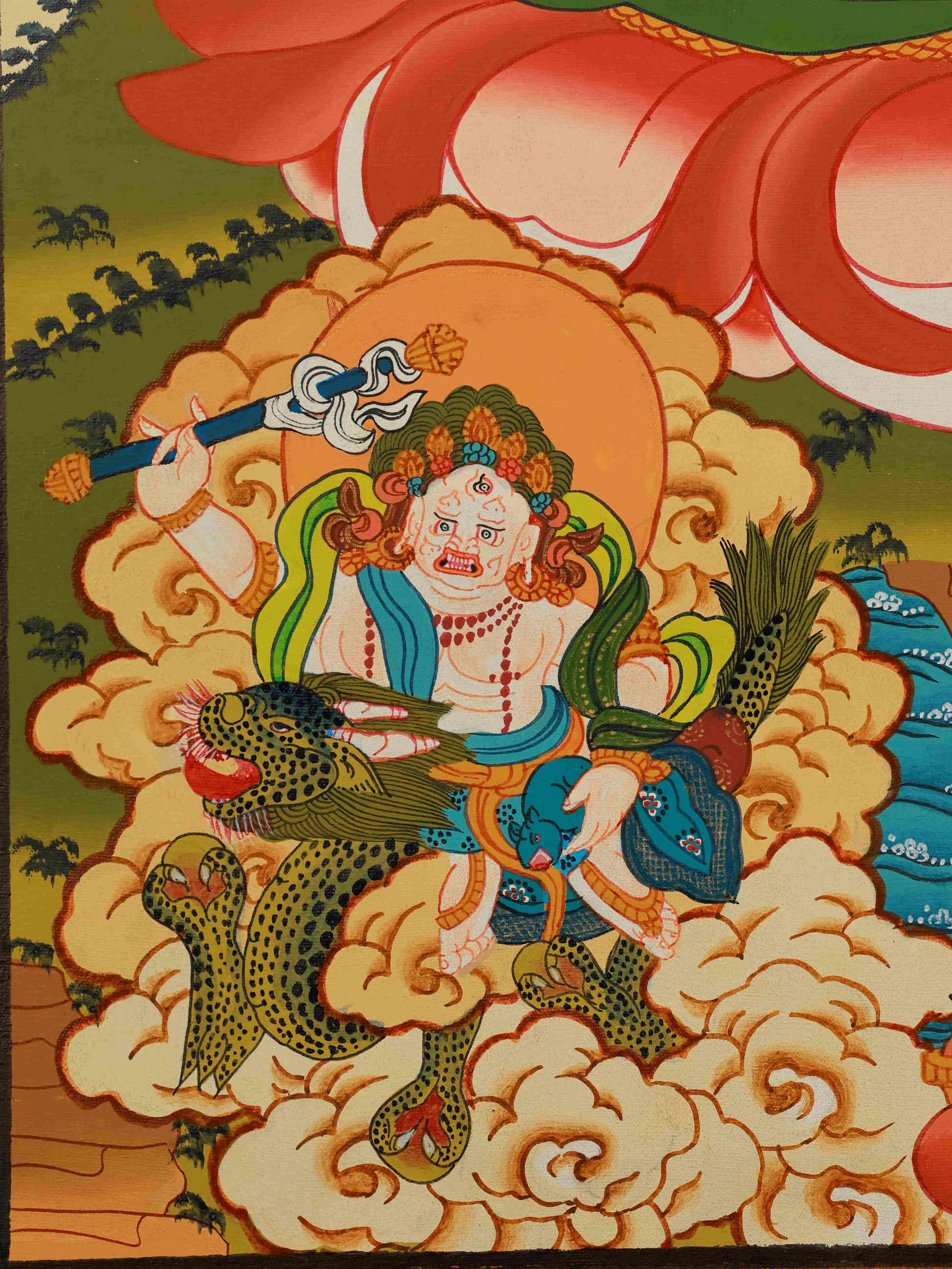 Close-up detail view of Yellow Jambhala Thangka painting, highlighting hand-painted craftsmanship and sacred colors.