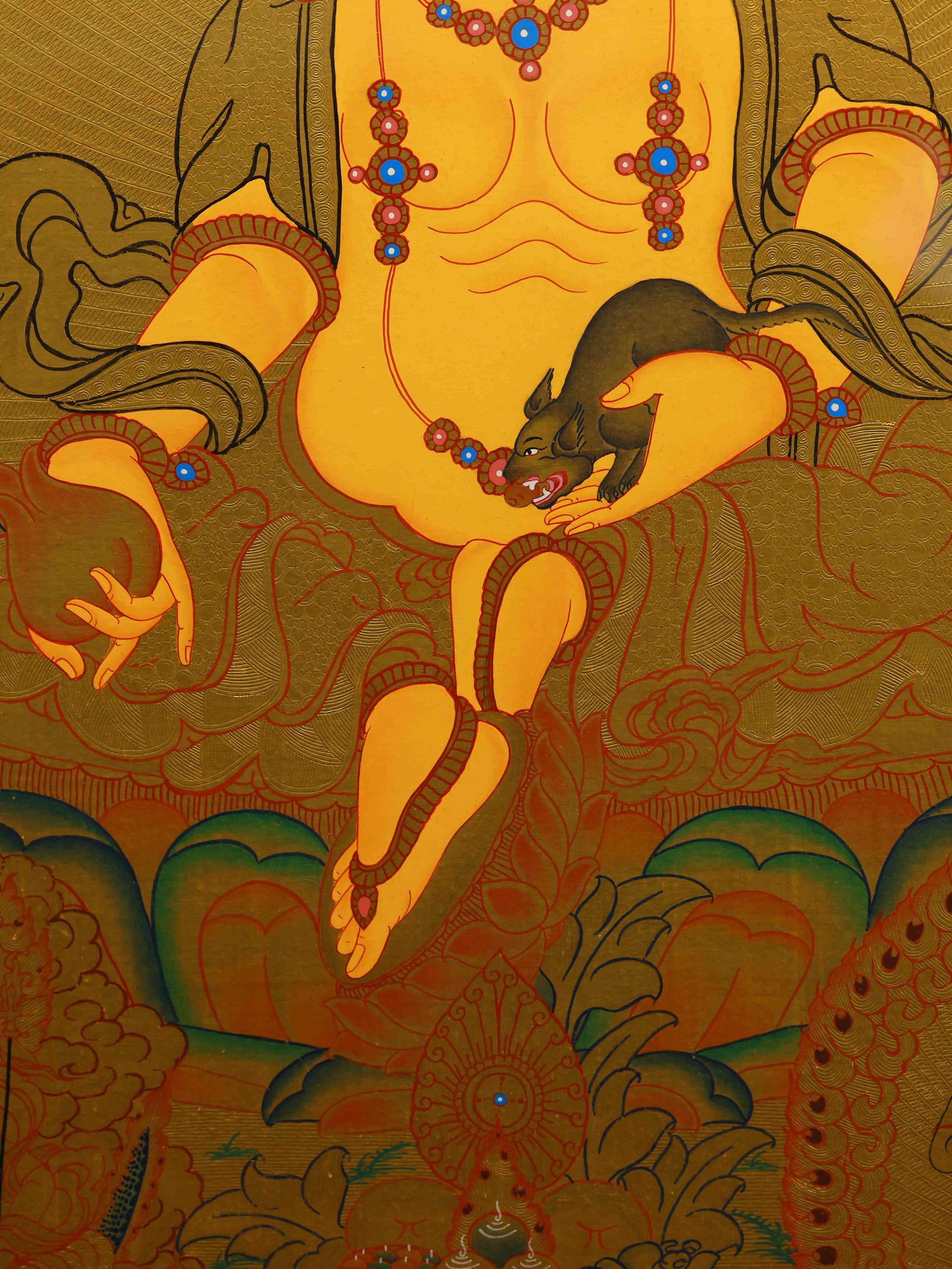 Tibetan Thangka painting of Yellow Jambhala Buddha, handmade with natural mineral pigments and gold foil.