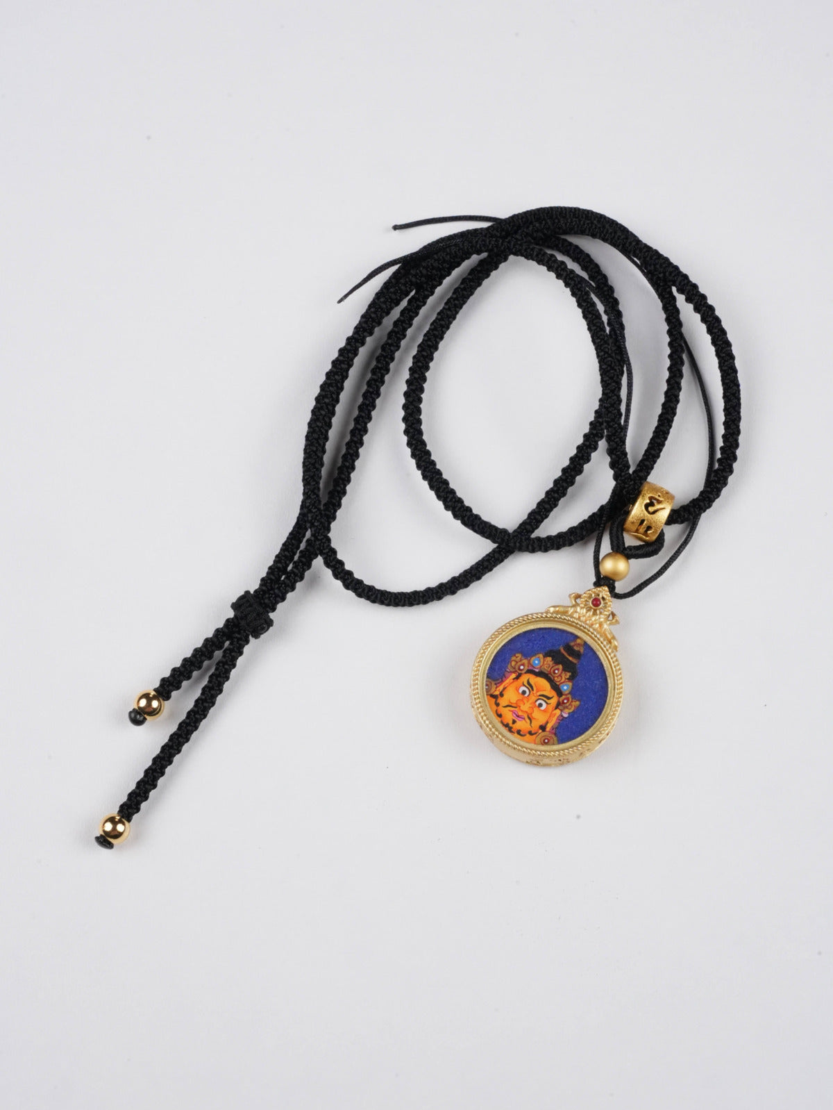 Yellow Jambhala thangka pendant with natural mineral pigments - authentic hand-painted craftsmanship