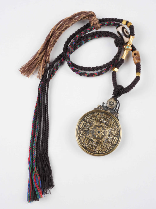 Round Tibetan Gau box pendant with Zakhi Lhamo deity, hand-painted with mineral pigments.