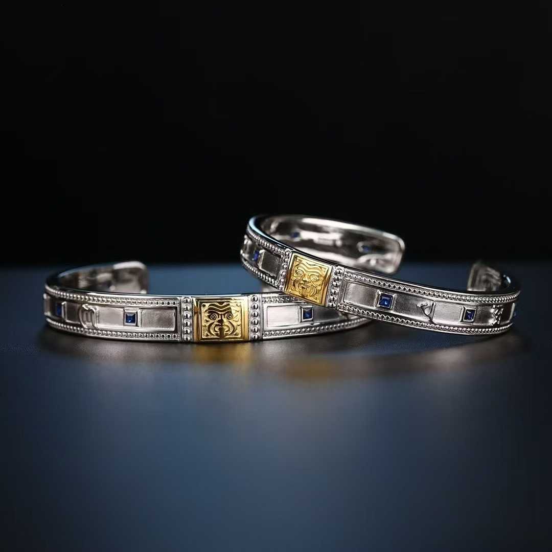 Handcrafted gold and silver Zakiram bangle inspired by Tibetan sacred jewelry art.