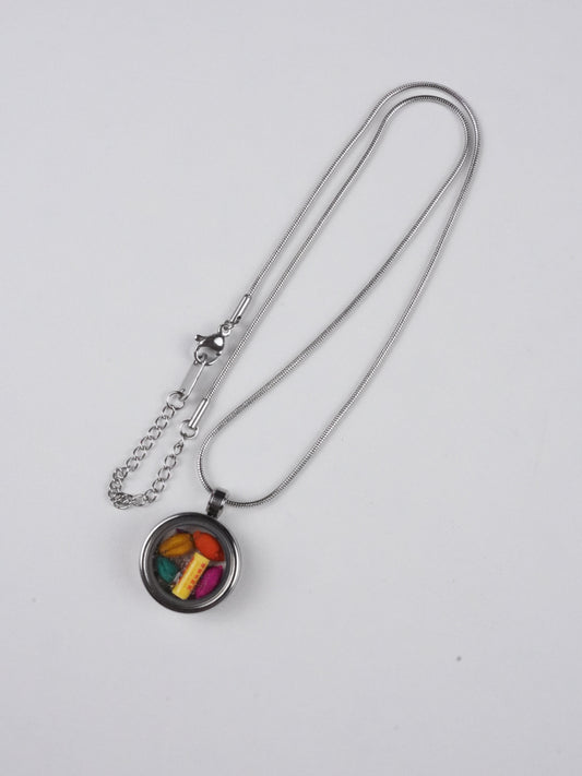Vibrant candy-style tibetan-buddhist pendant made from thangka fabric and natural mineral pigments, handmade in the tradition of Tibetan Buddha art for spiritual charm.