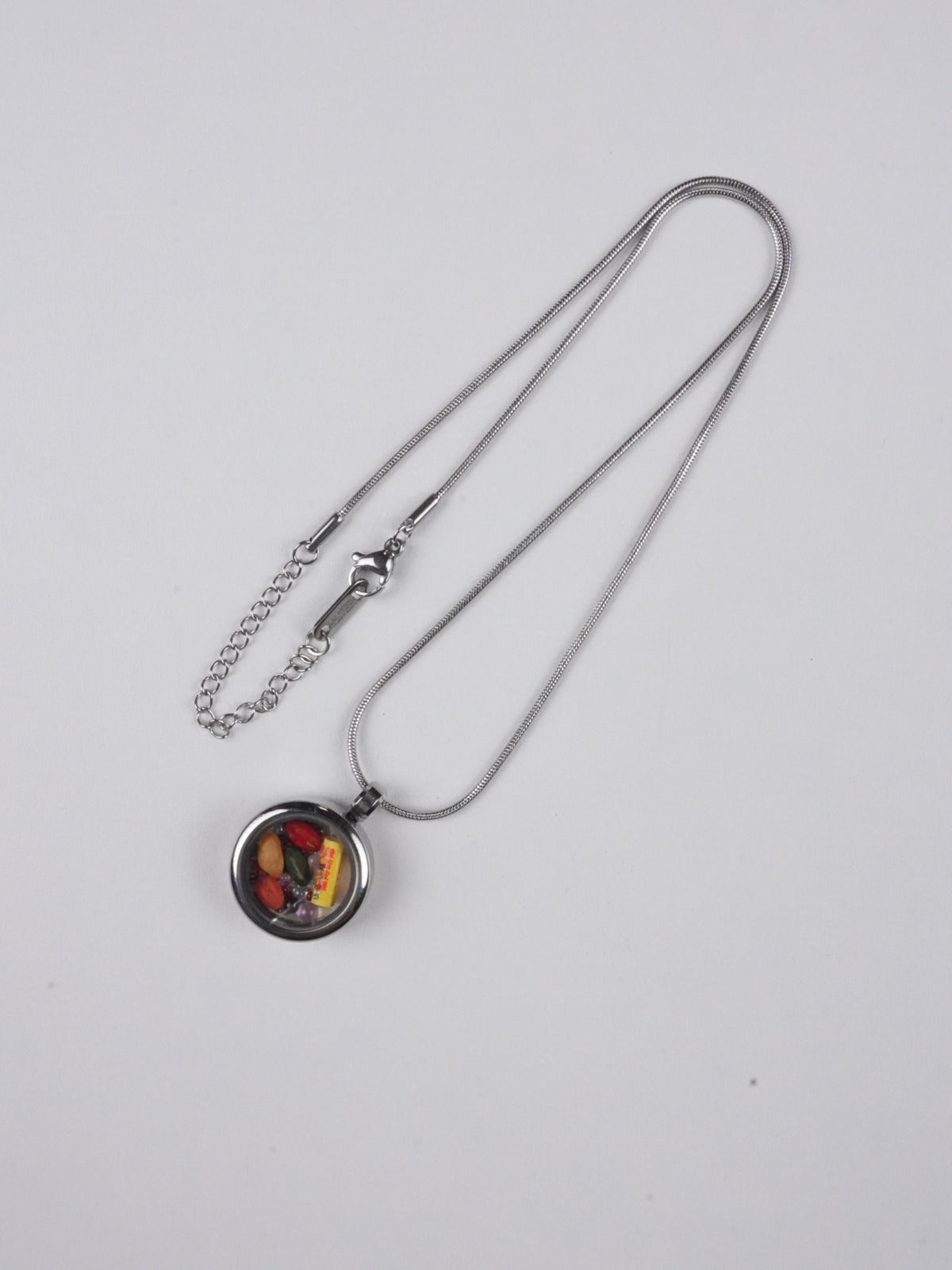 Tibetan-buddhist candy pendant painted on thangka canvas using traditional mineral pigments, representing creative energy and peace in Tibetan Buddha art.