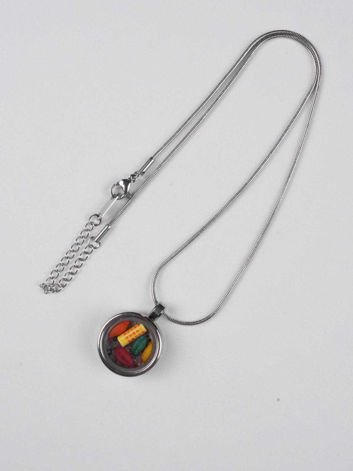Handcrafted tibetan-buddhist thangka pendant with colorful candy design, an artistic fusion of Tibetan Buddha art and sacred symbolism for protection and positivity.