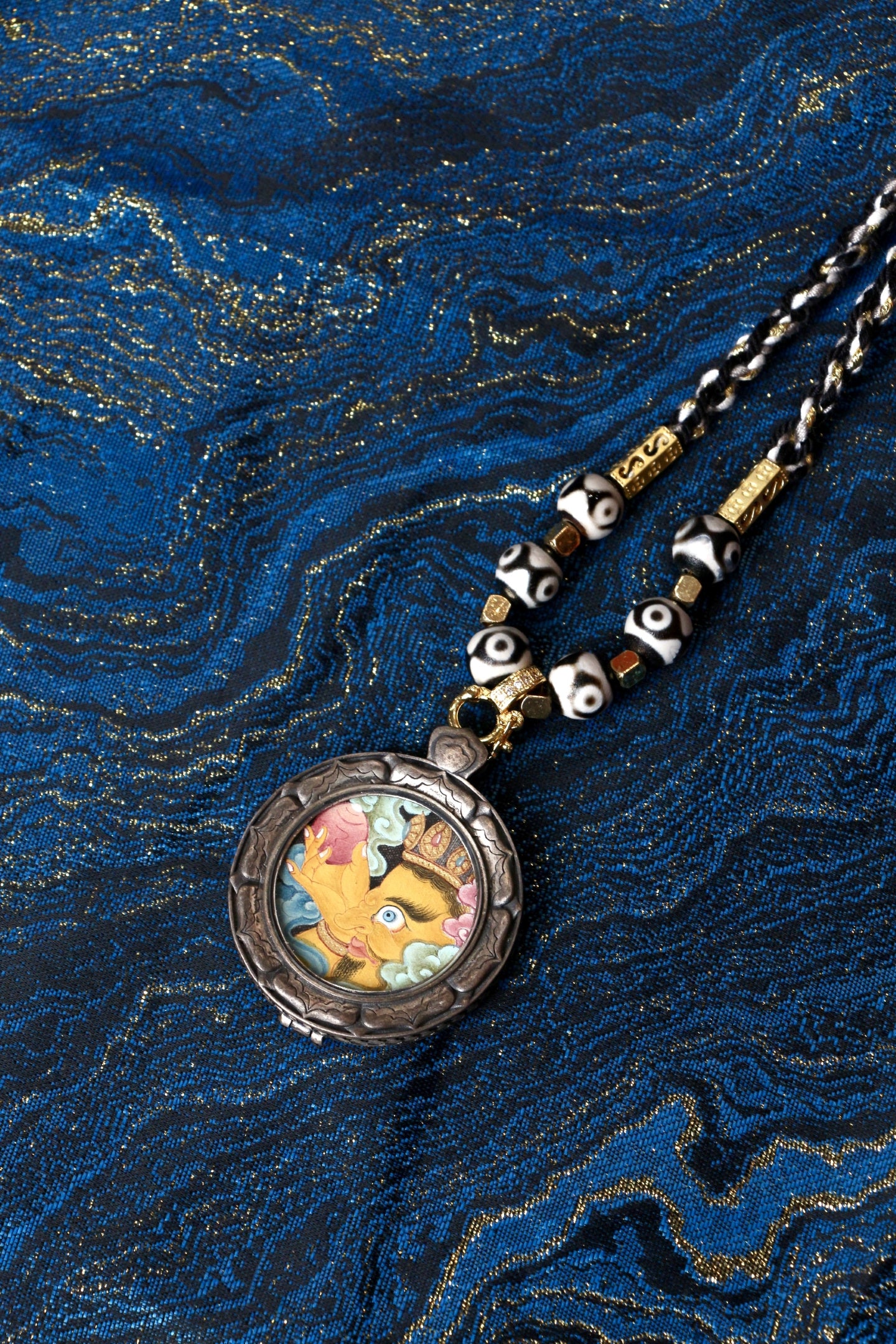 Detail of the exclusive S925 silver casing with the Three Rabbits Sharing Ears motif, protecting the Ruyi Yellow Jambhala artwork.