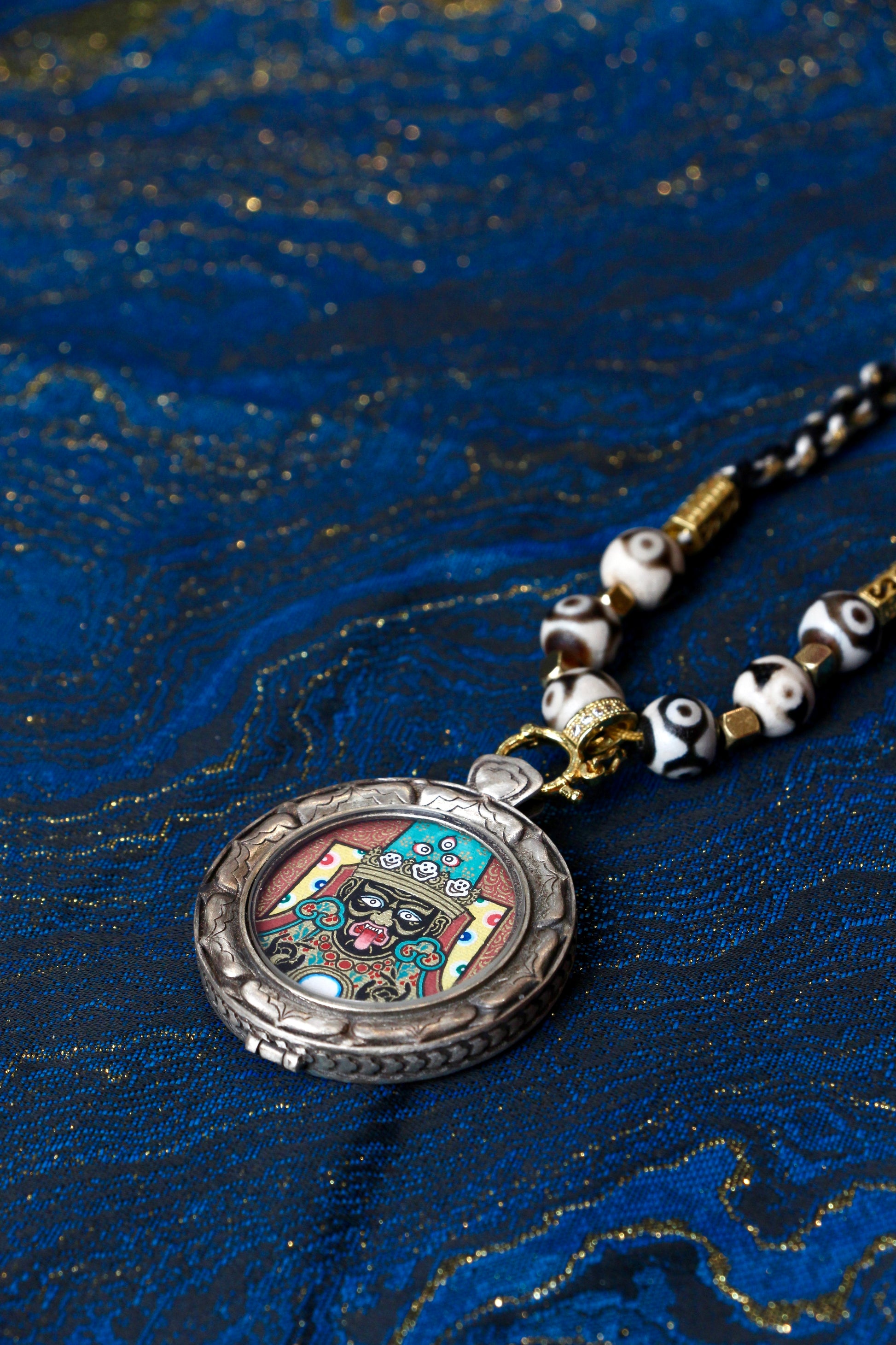 Close-up of the exclusive S925 silver casing with the Three Rabbits Sharing Ears motif, a signature feature of this wealth amulet.